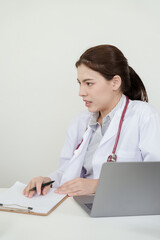 Asian orthopedic female doctor explains joint pain condition while reviewing notes on clipboard...