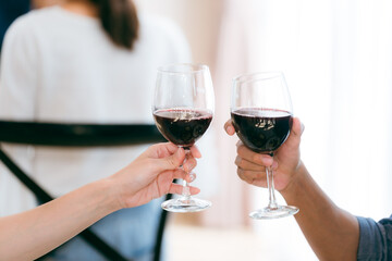Family and friends raise their glasses to celebrate a joyful evening filled with laughter wine delicious food and the warmth of togetherness during a special festive gathering