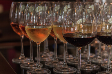 Wine glasses filled with red, white, and rose wine for a wedding celebration