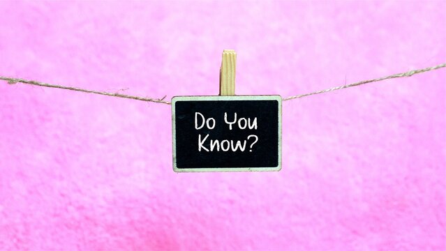 The words "Do You Know?" are on a mini chalkboard hanging from a string. A beautiful pink background. - Powered by Adobe