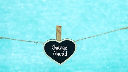 CHANGE AHEAD symbol. CHANGE AHEAD written on a mini whiteboard in the shape of love. light blue...