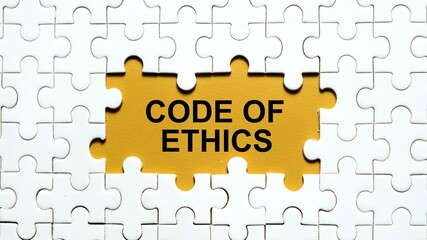 Conceptual image of a missing puzzle piece showing the text 'CODE OF ETHICS' on a yellow background.	