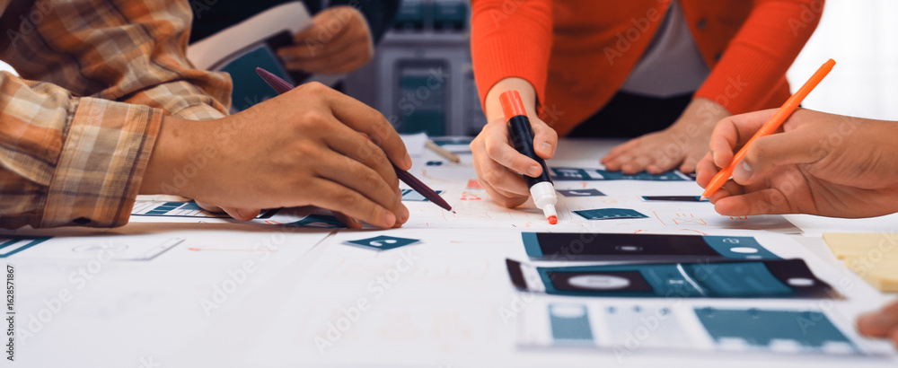 Aufkleber a close-up view of hands engaged in a creative design project, using colorful markers and paper in a