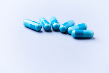 Amino acids capsules on bright background. Soft focus. Close up. Copy space.	
