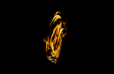 Artistic capture of fire spinning performance using long exposure photography, highlighting motion and intensity of flame trails in an otherwise pitch-black environment.