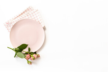 Stylish table setting with empty plate and napkin - flowers decorated on white background, top view, flat lay