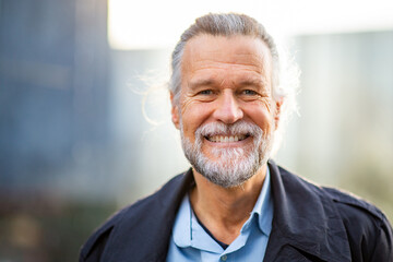 Smiling senior man outdoors with natural light