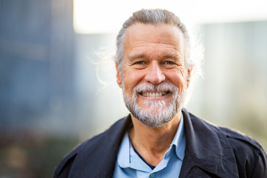 Smiling senior man outdoors with natural light