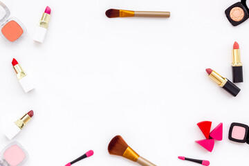 Flatlay of makeup cosmetics on white background. Blusher, mascara and lipstick, top view