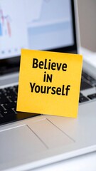 Motivational sticky note on laptop