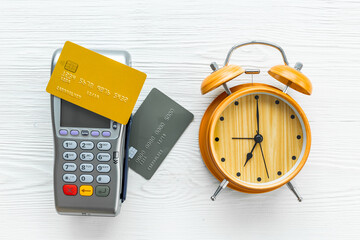 Pos payment terminal with bank card and alarm clock. Transaction speed. Time to pay concept