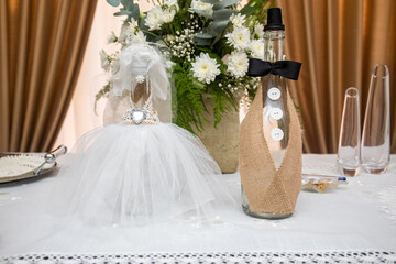 Beautifully crafted wedding decoration showcasing creative bottle designs with elegant floral...