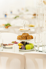 Elegant dessert display at a stylish banquet during a sunny afternoon in a bright, airy venue