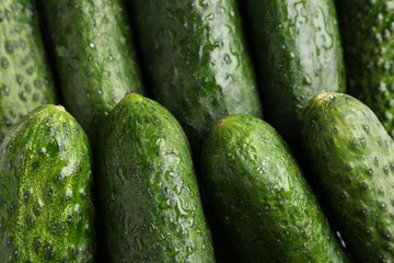 Fresh wet cucumbers as background, above view