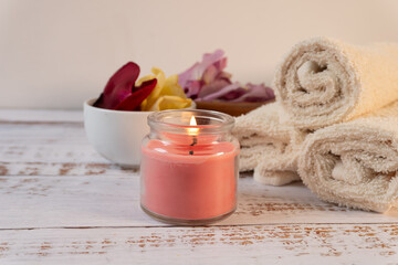 Spa composition with scented candles, flowers, and towels