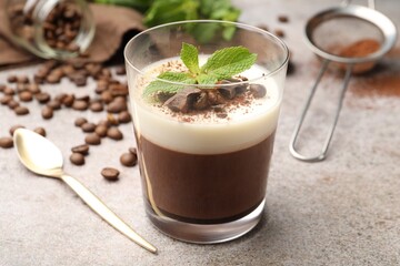 Delicious coffee panna cotta, beans and mint on grey table, closeup