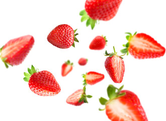 Yummy fresh strawberries swirling in air against white background