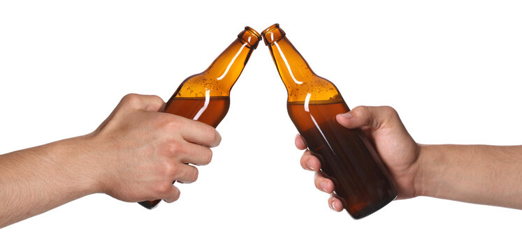 Men clinking their bottles of beer together against white background