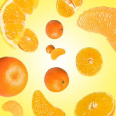 Sweet tangerines whirling in air against yellow background