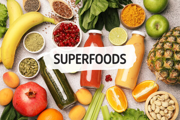Superfoods. Healthy smoothies in glass bottles and ingredients on table, top view