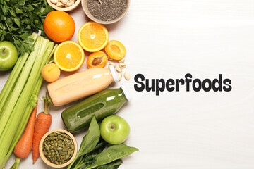 Superfoods. Healthy smoothies in glass bottles and ingredients on table, top view