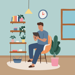 Young Man Looking at Tablet at Home Interior Background