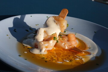 Boiled shrimp with ice and spices on a black background
