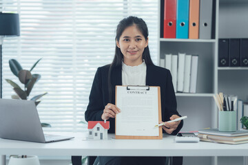 Female hand signing business document, female putting signature on legal paper making investment.