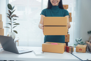 Online Shop Delivery: A cheerful individual with boxes ready to send product for shop customers,...