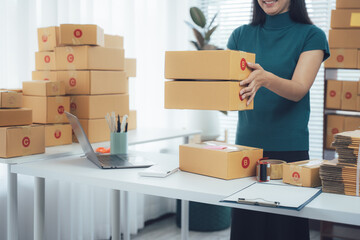 Package Processing: A skilled individual meticulously organizes a stack of cardboard parcels,...