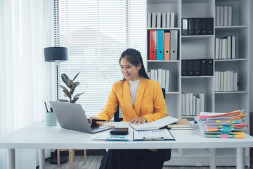 Focused Executive: A composed executive, exuding competence, meticulously works at her desk,...