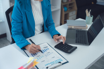 Desk Workspace with Analytical Approach: An individual engrossed in the intricacies of financial...