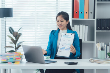 Smart Businesswoman in Online Meeting: A dynamic business professional, elegantly dressed, engaging in a virtual meeting while presenting financial reports with a smile.