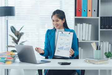 Business Presentation: A professional woman presents financial data and graph on a clipboard, engaged in a video conference meeting, demonstrating modern business communication.
