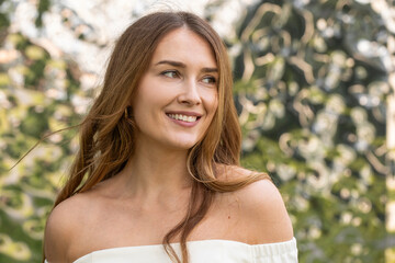 Young beautiful model in a white short dress with long sleeves