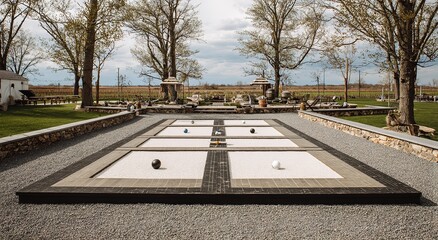 Obraz premium Empty Bocce Court with White Sand and Black Pebbles in a Grassy Park — Minimal Outdoor Recreation Scene