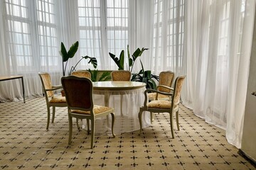 Bright and airy dining area within a medieval castle renovation, highlighting rococo-inspired...