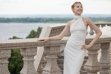 Young beautiful woman in a long white dress