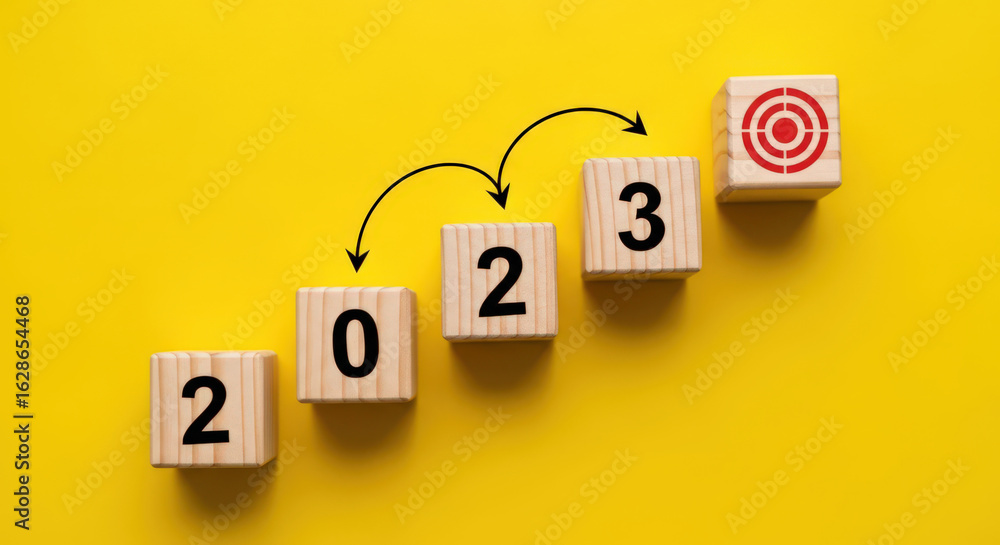 Poster strategic 2023 goals visualized with wooden blocks ascending towards target symbolizing progress and