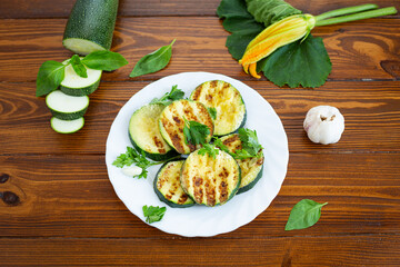 Grilled zucchini slices on dark wooden background