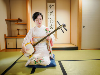 着物で三味線を演奏する女性