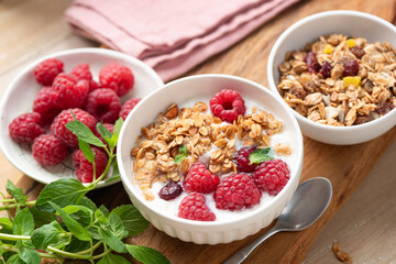 Muesli with berries and yogurt in bowl, healthy meal