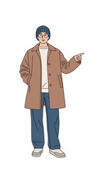 Obraz premium A stylish young man in a trendy outfit with a coat and beanie, pointing to the side. Full-length character illustration on a white background.