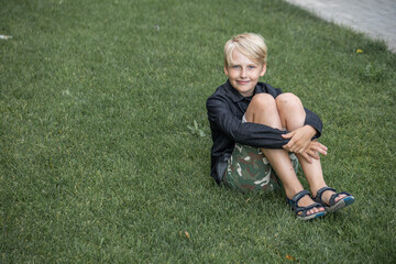 Fototapeta premium Portrait of a blond teenage boy on the street
