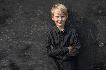 Portrait of a blond teenage boy on the street