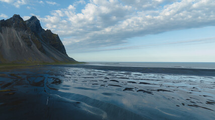 Fototapeta premium Vestrahorn Mountain and Black Sand Beach in Iceland's Coastal Landscape