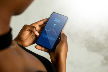 Person Using Stock Market App on Smartphone