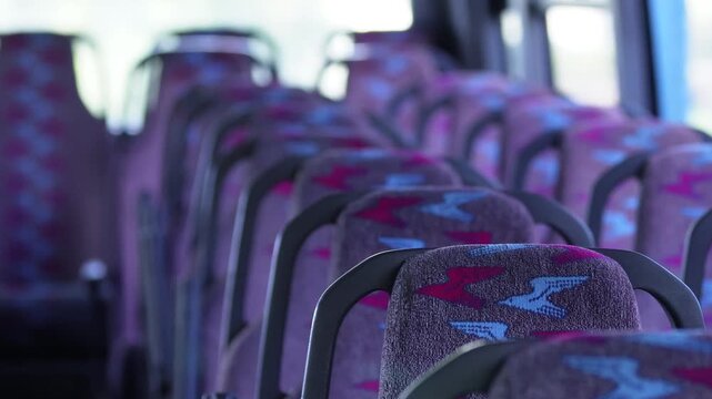 Empty bus interior with central aisle - clean, modern public transport. Modern empty bus interior with central aisle - ideal for passenger, tourist and urban transportation