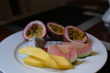 Assortment of exotic tropical fruits, top view. Passionfruit, dragonfruit, mango. Fresh food...