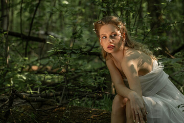 Portrait of a young beautiful girl in the image of a forest nymph